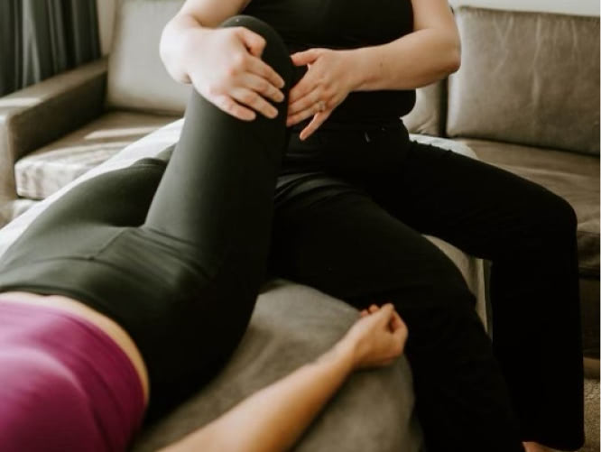 Woman is providing Reflexology services by focused stretching.