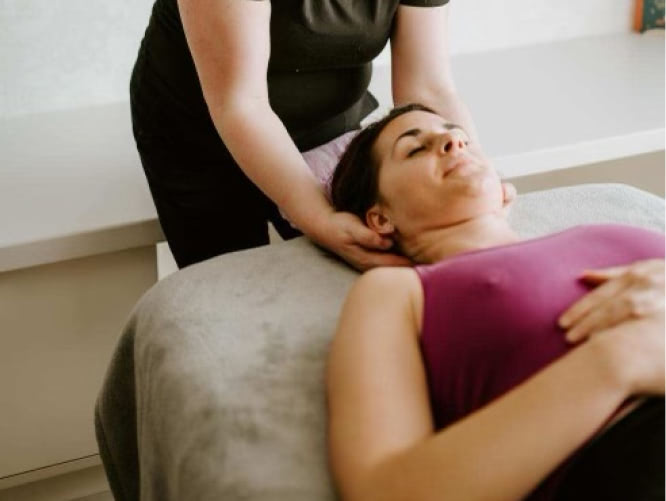 Woman seeking stress relief through deep tissue massage.